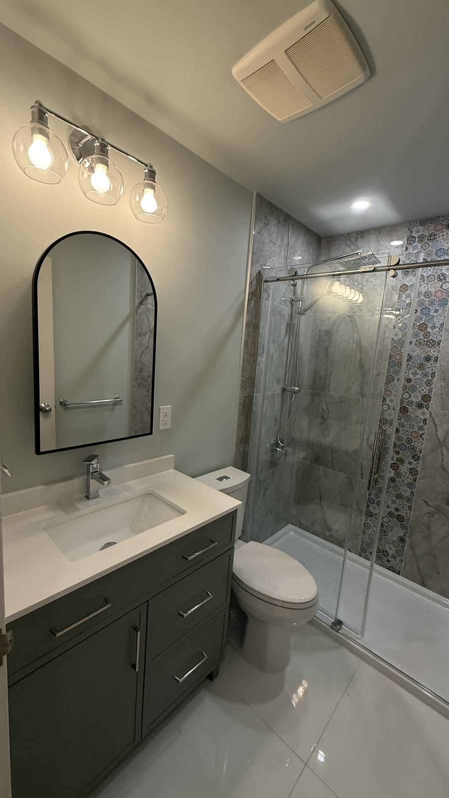 Budova bathroom renovation with vanity, mirror, lighting and tiled shower