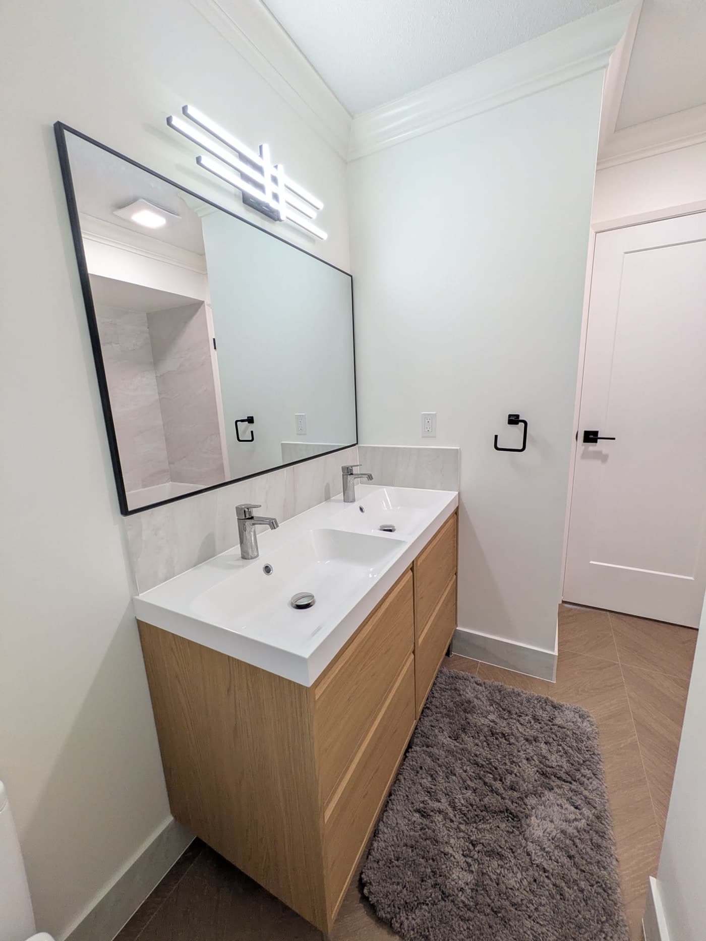 New double vanity and mirror in completed Burnaby bathroom