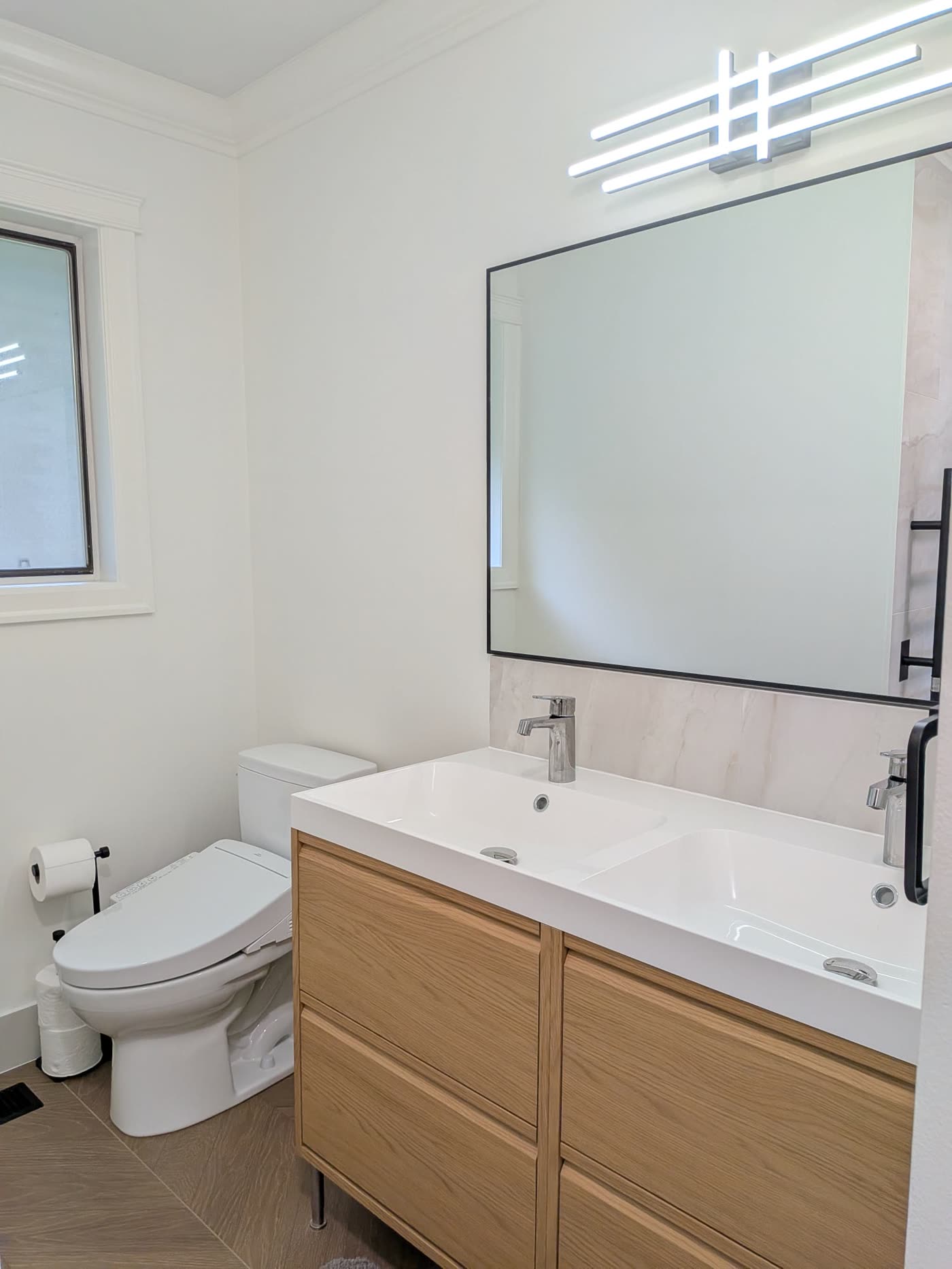 Finished double sink vanity toilet and tile floor in Burnaby